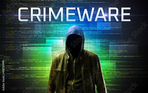 Faceless hacker with CRIMEWARE inscription on a binary code background