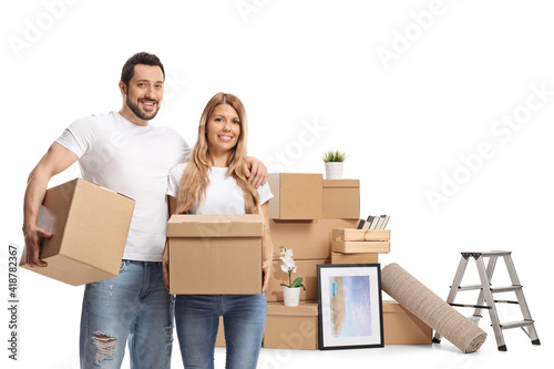 Young couple with a pile of cardboard boxes packing for home removal