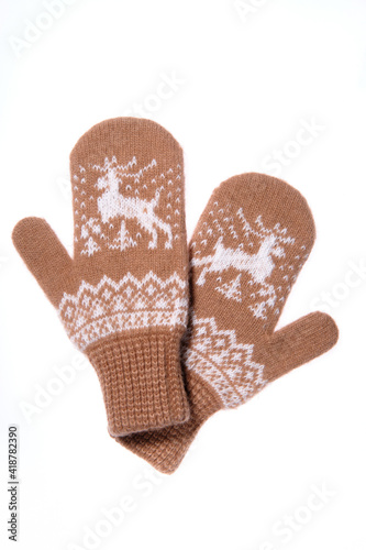 Warm woolen knitted mittens isolated on white background. Brown