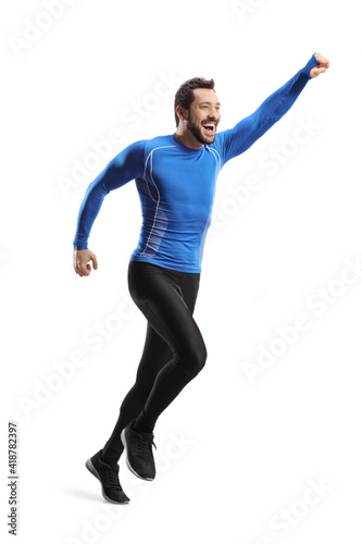 Full length shot of a fit man in sportswear running and gesturing happiness