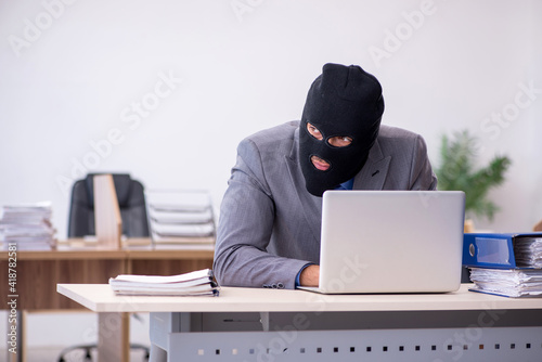 Konstfotografi Young male employee in industrial espionage concept
