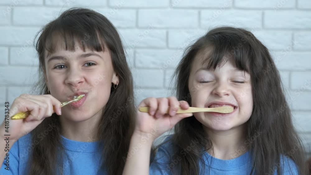 Children with a toothbrush. Beautiful little girls brush their teeth together. Children with a toothbrush. Beautiful little girls brush their teeth together.