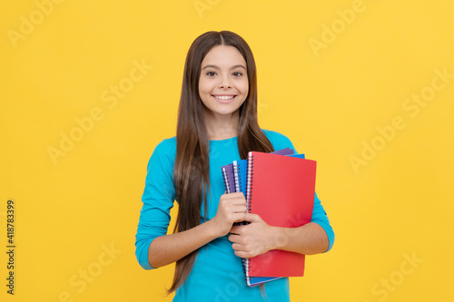 cheerful child girl hold notepad for homework, homework