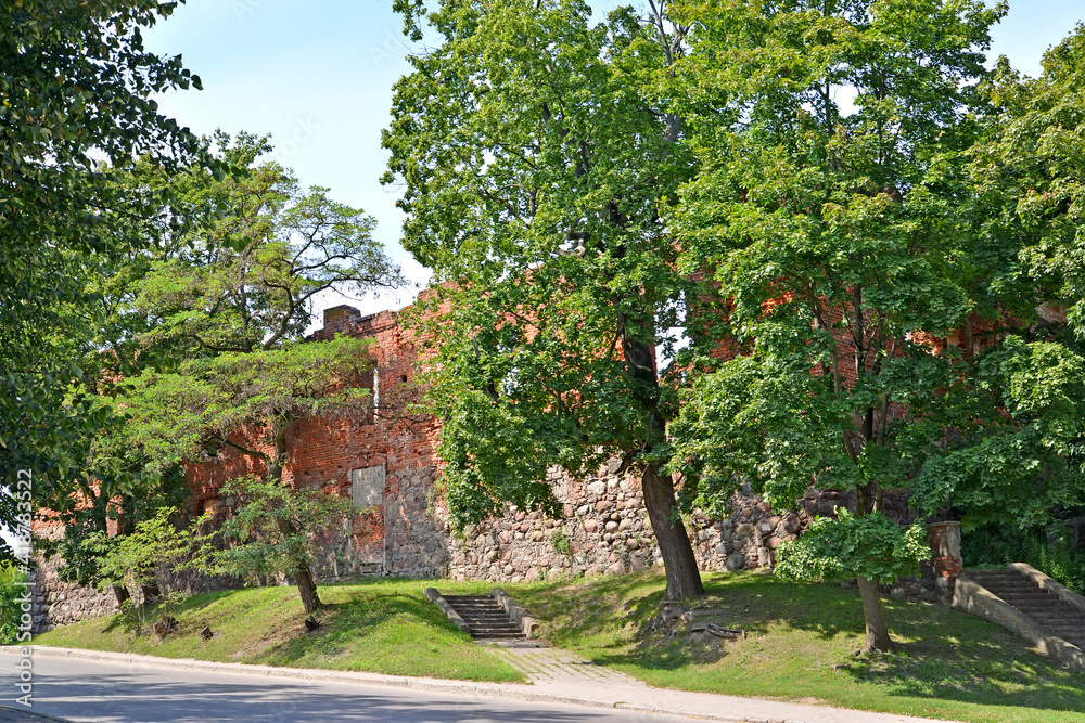 View of the fortress wall of Insterburg Castle on a summer day (XIV century). Chernyakhovsk, Kaliningrad region