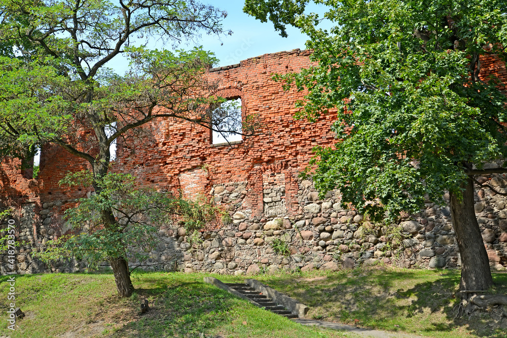 A fragment of the fortress wall of Insterburg Castle on a summer day (XIV century). Chernyakhovsk, Kaliningrad region