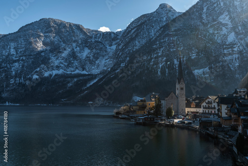 Hallstatt old town in winter blue day with church with tower in Austria