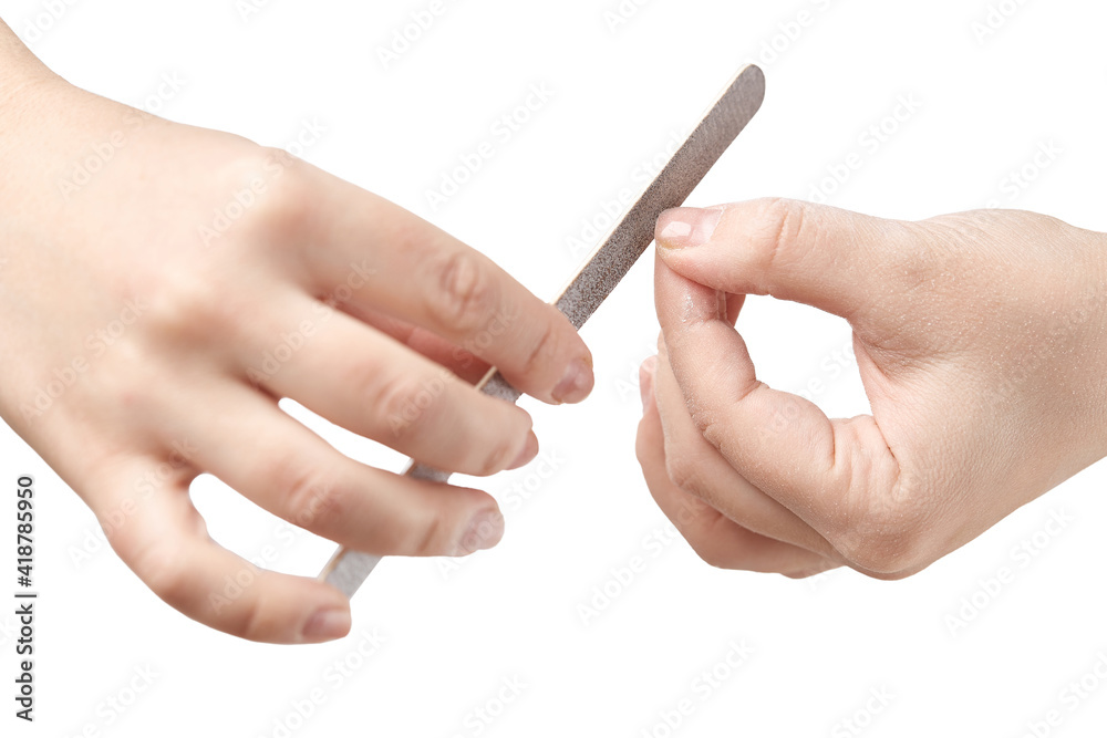 A woman does a manicure at home and uses a nail file to remove old gel polish from her nails. Close-up of a hand using a nail buffer when performing a manicure, polishing nails at home. A woman does a manicure at home and uses a nail file to remove old gel polish from her nails. Close-up of a hand using a nail buffer when performing a manicure, polishing nails at home.