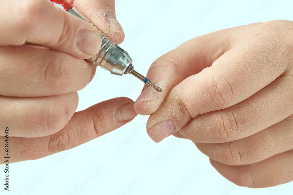 Flame cutter for cuticle treatment during hardware nail manicure. Hardware manicure at home. The girl makes herself a hardware manicure at home. Cuticle treatment close-up. Flame cutter for cuticle treatment during hardware nail manicure. Hardware manicure at home. The girl makes herself a hardware manicure at home. Cuticle treatment close-up.