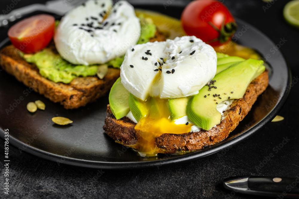 Poached egg on toast. Sandwich with avocado and Poached Egg
