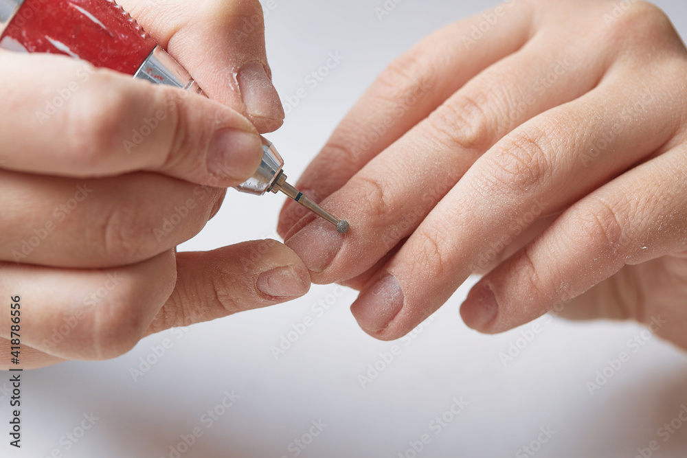 Ball cutter for cuticle treatment during hardware nail manicure. A bit for hardware manicure. Hardware manicure at home. The girl makes herself a hardware manicure at home. Ball cutter for cuticle treatment during hardware nail manicure. A bit for hardware manicure. Hardware manicure at home. The girl makes herself a hardware manicure at home.