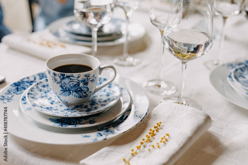 Blue vintage porcelain tea set on a table at a cafe.