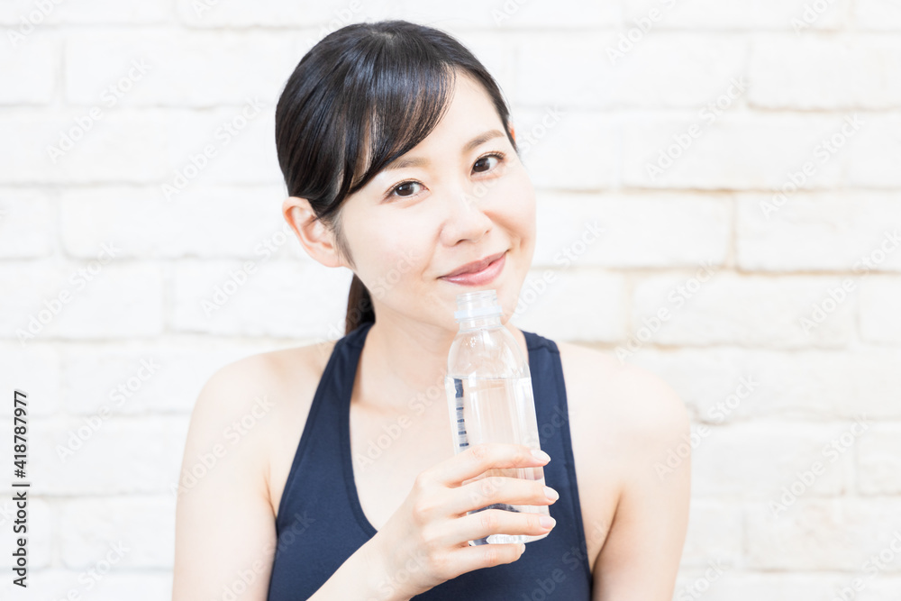 Woman drinking water after yoga