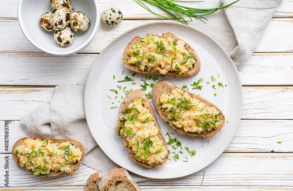 Healthy breakfast, scrambled quail eggs topped with chopped chives Healthy breakfast, scrambled quail eggs topped with chopped chives