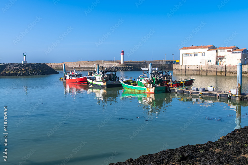 Oleron island in France, the typical harbor of the Cotiniere, with the lighthouse and fishing boats
