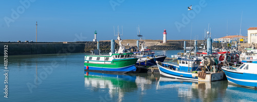 Oleron island in France, the typical harbor of the Cotiniere, with the lighthouse and fishing boats
