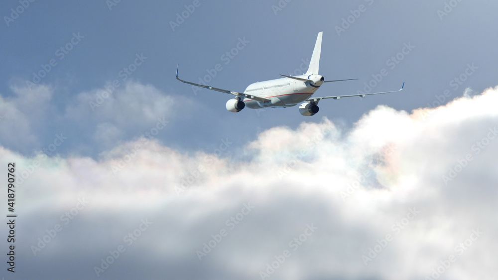 Fototapeta premium Zoom photo of Airbus A320 passenger plane flying above deep blue cloudy sky
