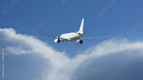 Zoom photo of passenger plane flying above deep blue cloudy sky © aerial-drone