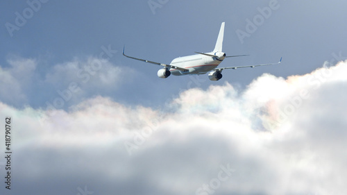 Zoom photo of Airbus A320 passenger plane flying above deep blue cloudy sky