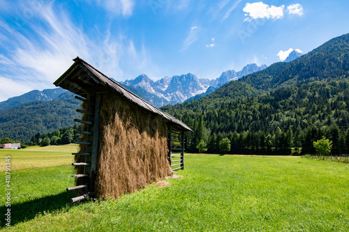 Kozolec - slovenian typical hayrack with beautiful panorama of Julian Alpes, Slovenia photo