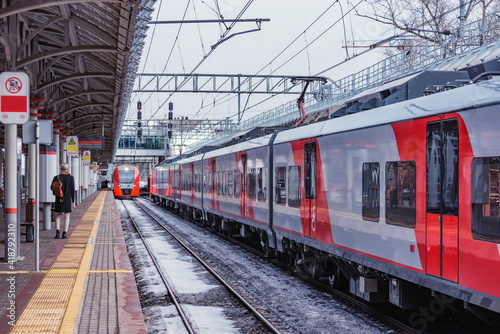Highspeed trains by the station platform at winter day.