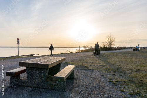 Richmond, BC, Canada - MAR 03 2021 : People enjoy the sunset scenery in Garry Point Park. © Shawn.ccf
