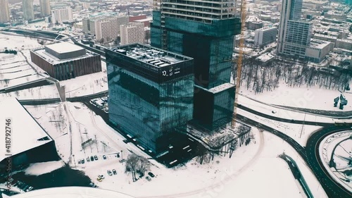 Modern glass office skyscrapers under construction .KTW in Katowice, Poland in snowy winter aerial drone view 4k photo