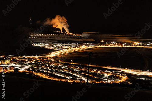 Image of the Iron Ore Mine in Kiruna, Sweden at night. Lights illuminating the mine with thick smoke in a freezing cold winter night.
 photo