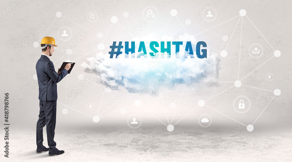 Engineer working on a social media concept with #HASHTAG inscription Engineer working on a social media concept with #HASHTAG inscription