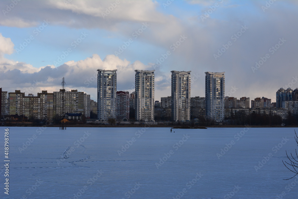 city ​​on the background of a frozen lake