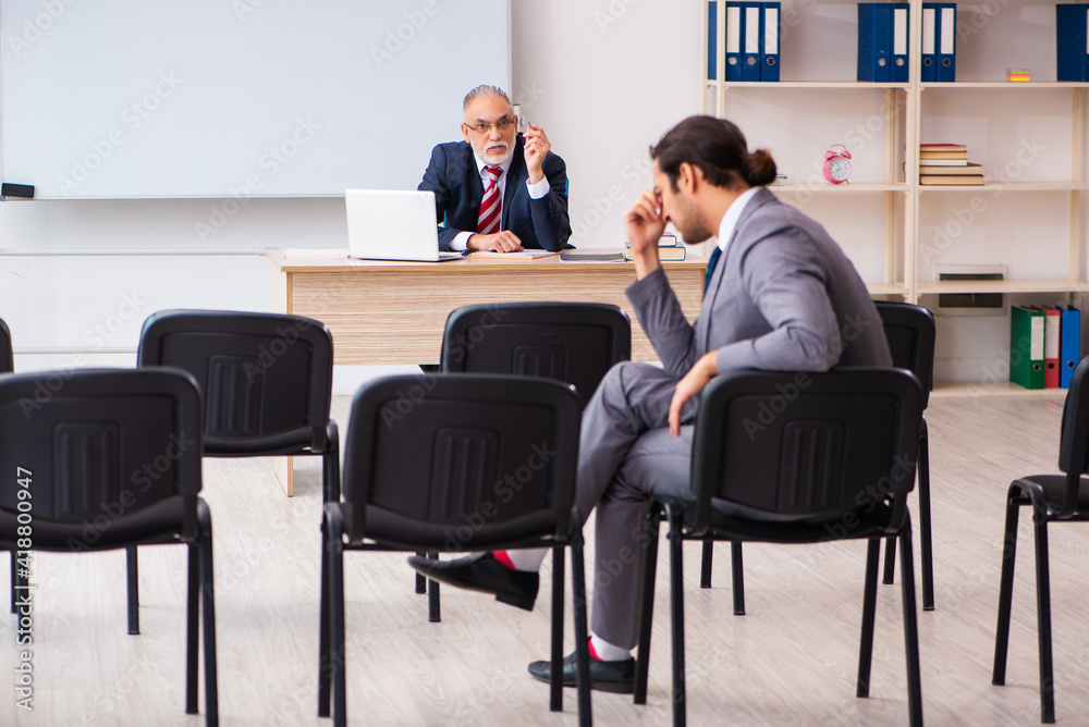 Two businessmen in the classroom in pandemic concept Two businessmen in the classroom in pandemic concept