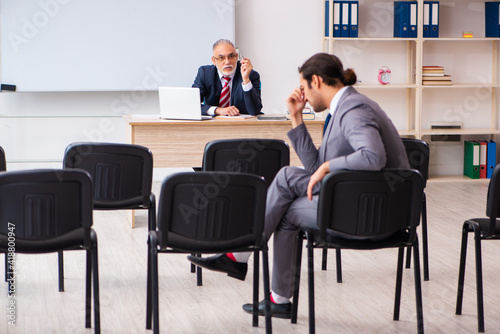 Two businessmen in the classroom in pandemic concept