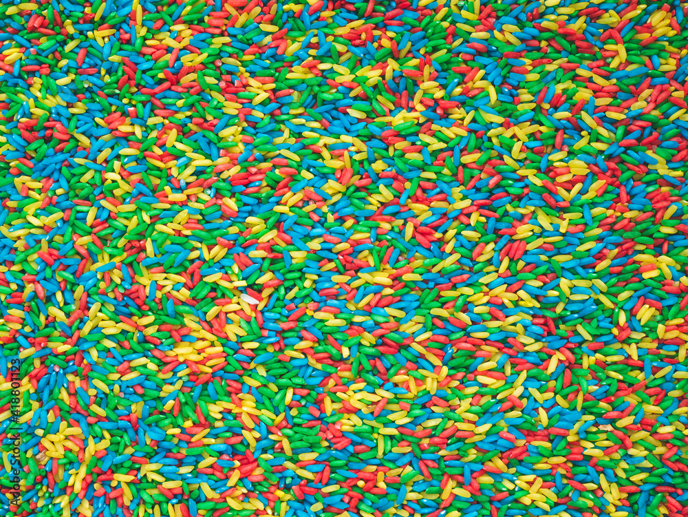 Texture of colored rice. Grain of red, green, yellow and blue colors. Bright mix Texture of colored rice. Grain of red, green, yellow and blue colors. Bright mix