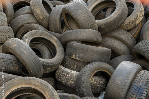 used car tires pile in the tire repair shop yard.