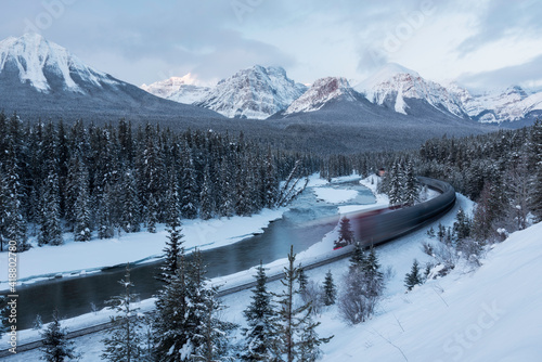 The Canadian Pacific Railway train whooshes by at Sunrise from Morants Curve. photo