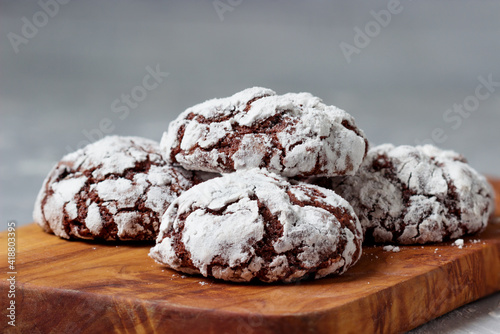 Cracked chocolate biscuits. Home baked chocolate crinkle cookies in icing sugar.