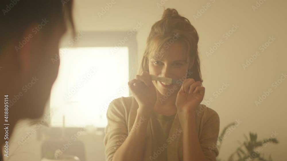 Young Couple In The Kitchen. Woman Shows Her Husband Positive Pregnancy Test.