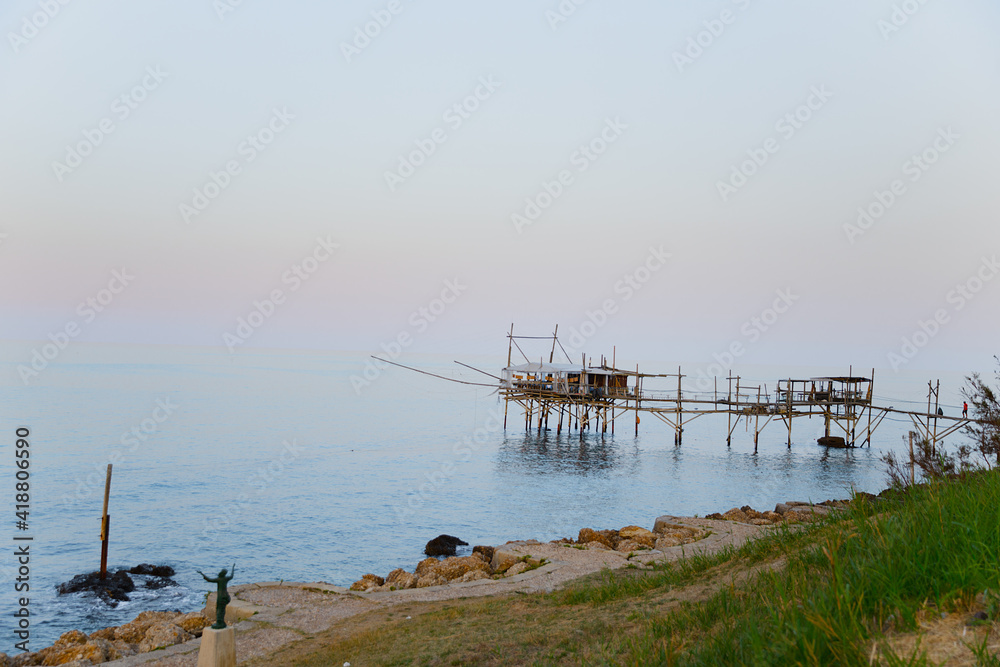 Traditional wooden fishing house in the sea in Italy