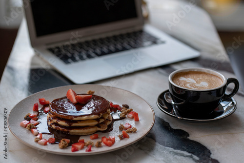 Fotografiet Pancakes topped with chocolate, stockberry, dessert, coffee latte to eat during