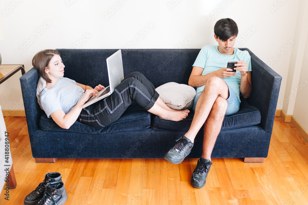 Young couple working on the sofa Young couple working on the sofa