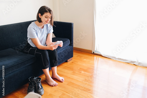young woman texting from home