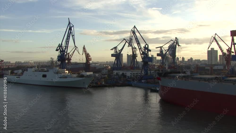 Sail in the Port of Shanghai, China. Cranes by the docks Sail in the Port of Shanghai, China. Cranes by the docks