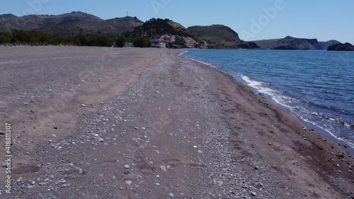 A low and fast drone flight towards the village of Skala Eresos.There is some wind and some waves.  photo