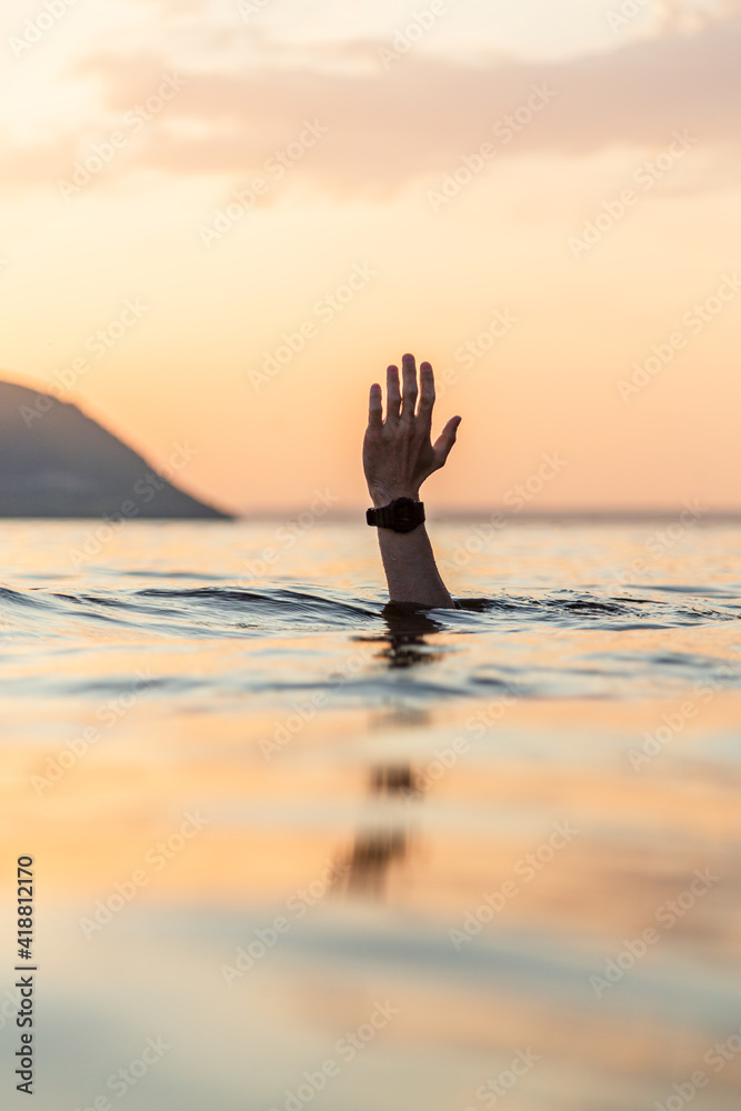 man hand in the sea 