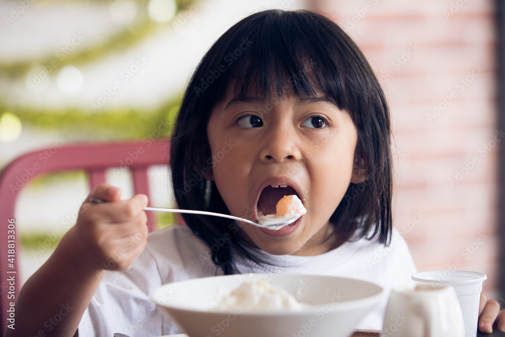 Cute girl eating food, kid with ice cream, child eating dessert Cute girl eating food, kid with ice cream, child eating dessert