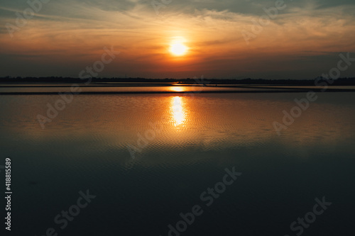 Colorful sunset landscape view of salt farm or salt pan in Thailand.