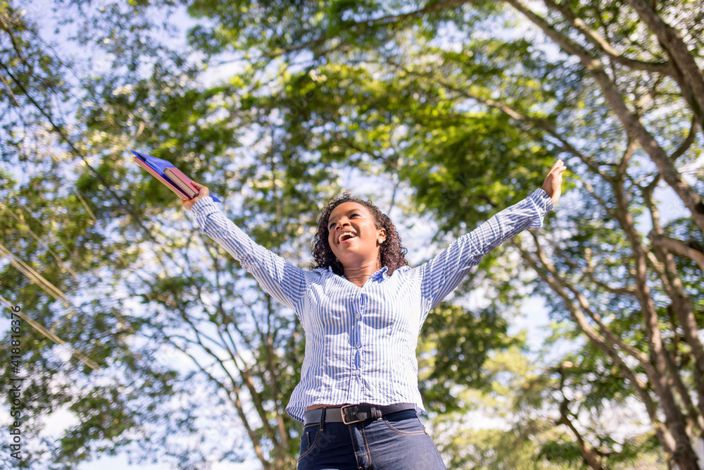 Student girl celebrating and having fun with arms raised. Student girl celebrating and having fun with arms raised.