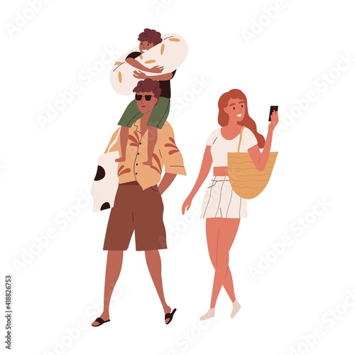 Happy family with child going to beach on summer holidays. Sun-tanned tourist...