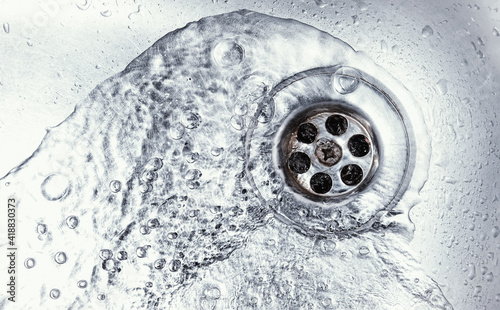 water drain down on stainless steel kitchen sink photo