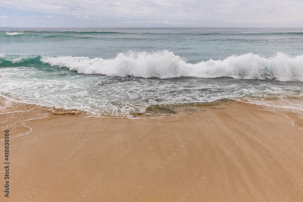 Seascape background. Sandy beach, milky foam waves, blue ocean. Scenic waterscape. Horizon line. Nature and environment concept. Daylight. Copy space. Dreamland beach, Bali Seascape background. Sandy beach, milky foam waves, blue ocean. Scenic waterscape. Horizon line. Nature and environment concept. Daylight. Copy space. Dreamland beach, Bali