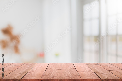 Empty wood table top and blurred coffee shop and restaurant interior background - can used for display or montage your products.
